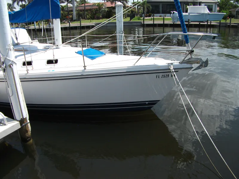 Slide: The Image of 1992 Catalina 30 MkII sailboat docked in a marina, featuring a sleek white hull. - 1