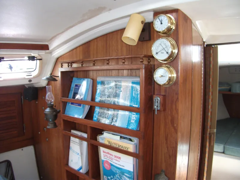 Slide: The Image of Interior of 1992 Catalina 30 MkII sailboat with wooden shelves and nautical instruments. - 11