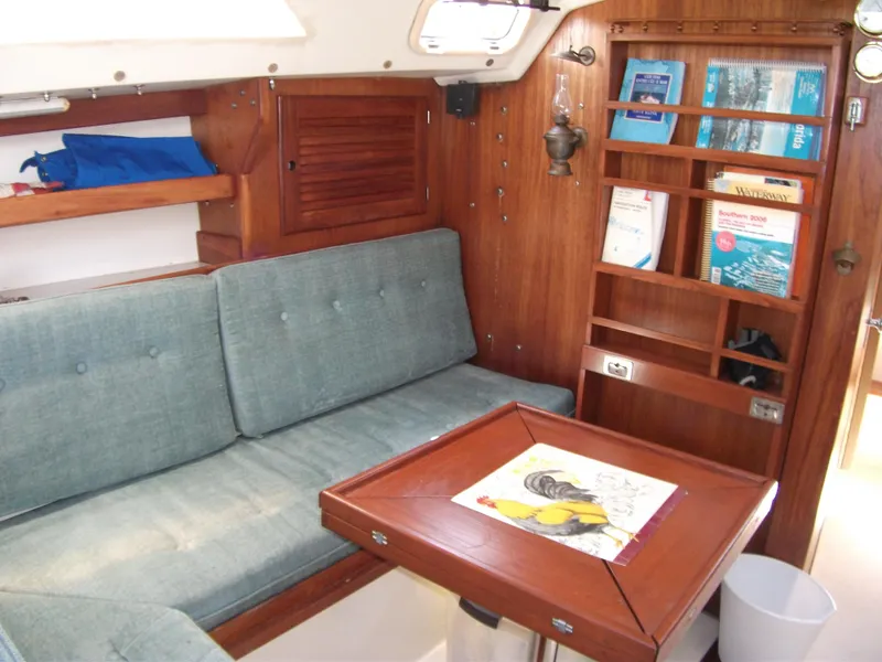 Slide: The Image of Interior of 1992 Catalina 30 MkII sailboat with wooden cabinetry and blue seating. - 13