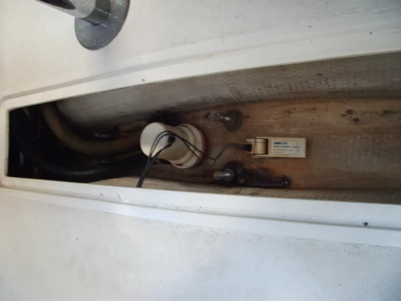 Slide: The Image of Bilge area of a 1992 Catalina 30 MkII sailboat, showing pump and wiring. - 24