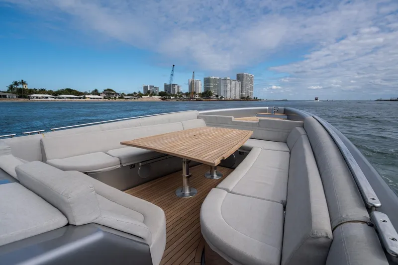Slide: The Image of Novamarine BS 160 Outboard 2022 boat with spacious seating and table, coastal cityscape view. - 37