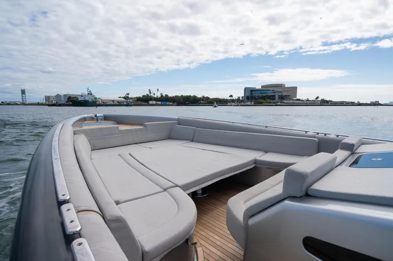 Slide: The Image of Novamarine BS 160 Outboard 2022 boat with spacious deck, cruising near coastal buildings. - 41
