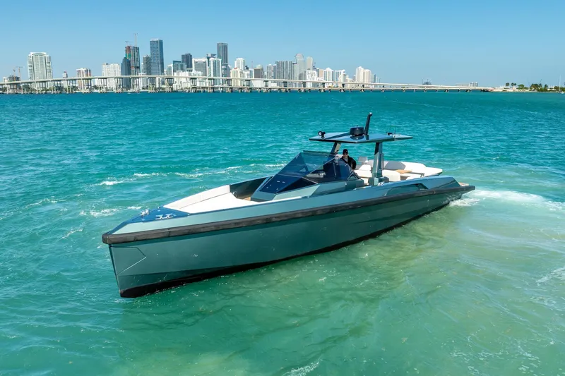 Slide: The Image of 2021 Wally 48 Wally Tender yacht cruising in turquoise waters near a city skyline. - 16