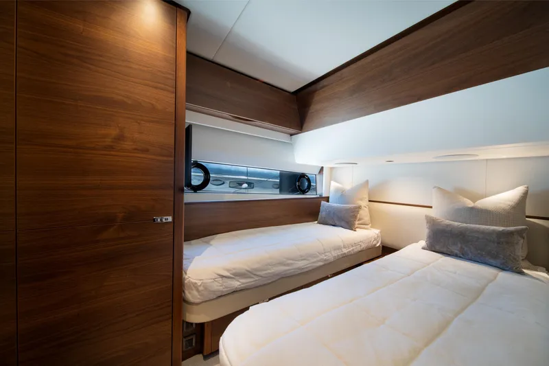 Slide: The Image of Luxurious twin cabin interior of 2025 Princess F65 yacht with modern wood finishes. - 31