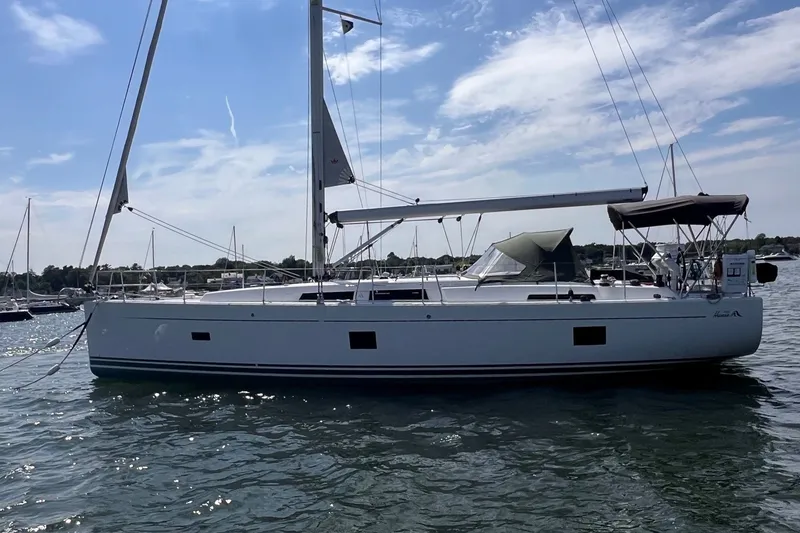 Slide: The Image of 2020 Hanse 458 sailboat on calm water under a clear blue sky. - 4