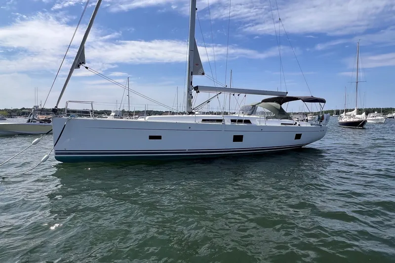 Slide: The Image of 2020 Hanse 458 sailboat on calm water under a clear blue sky. - 3