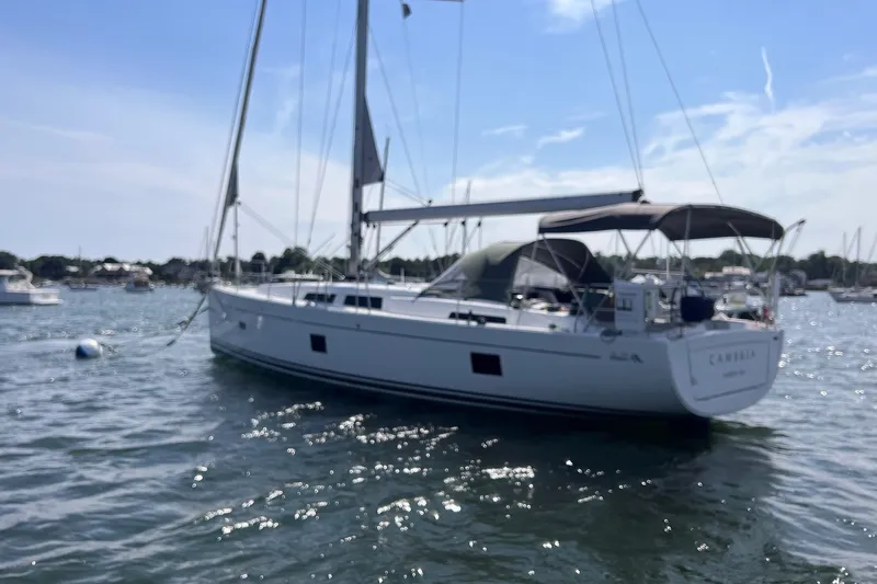 Slide: The Image of 2020 Hanse 458 sailboat anchored on a sunny day in a marina. - 6