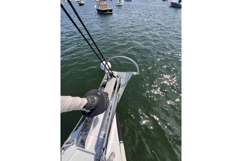 Slide: The Image of Bow of 2020 Hanse 458 sailboat on water, surrounded by other boats. - 9