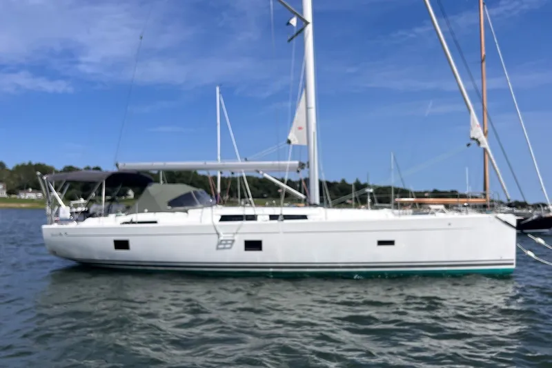 Slide: The Image of 2020 Hanse 458 sailboat on calm water under a clear blue sky. - 2