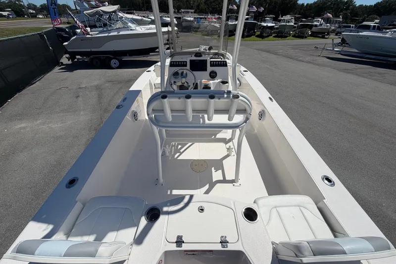 Slide: The Image of 2024 Robalo 206 Cayman boat interior with seating and console, displayed outdoors. - 12