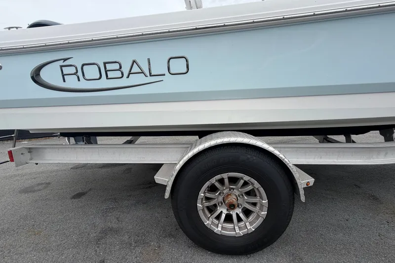Slide: The Image of 2024 Robalo 206 Cayman boat on trailer, side view with logo visible. - 68