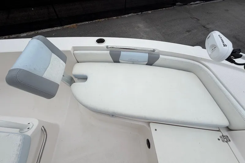 Slide: The Image of The image shows the bow cushion of a 2024 Robalo 206 Cayman boat with gray and white upholstery. - 26