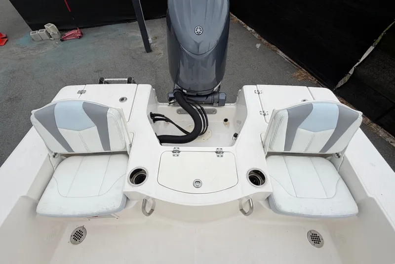 Slide: The Image of The image shows the stern of a 2024 Robalo 206 Cayman with two cushioned seats and an outboard motor. - 47