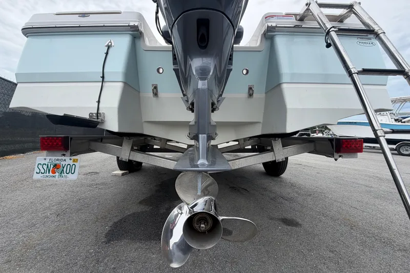 Slide: The Image of 2024 Robalo 206 Cayman boat rear view with outboard motor and Florida license plate. - 4