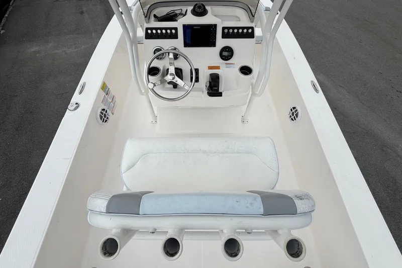 Slide: The Image of The image shows the cockpit of a 2024 Robalo 206 Cayman with a helm and seating. - 14
