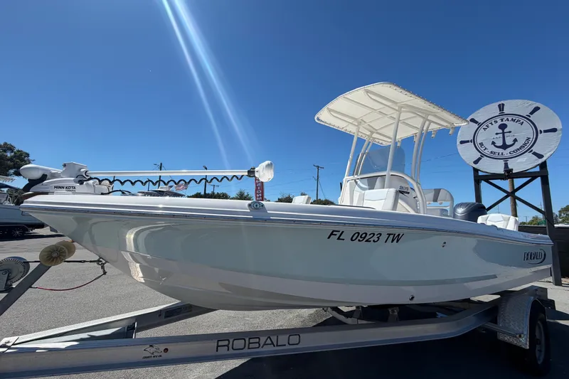 Slide: The Image of 2024 Robalo 206 Cayman boat on trailer under clear blue sky. - 8