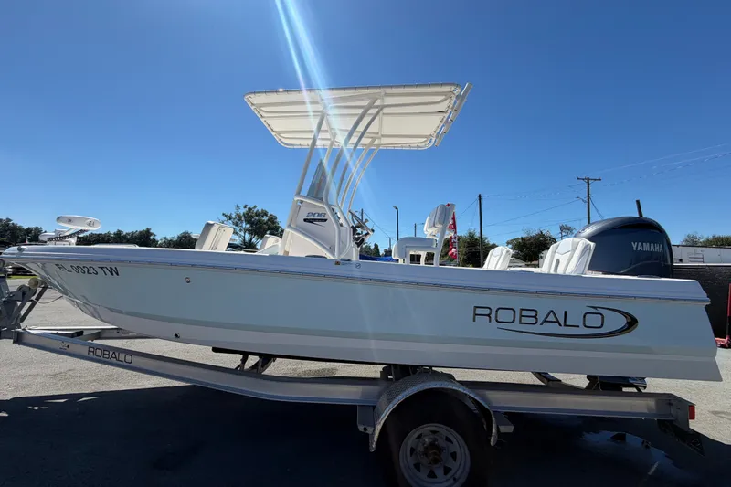 Slide: The Image of 2024 Robalo 206 Cayman boat on trailer under clear blue sky. - 7