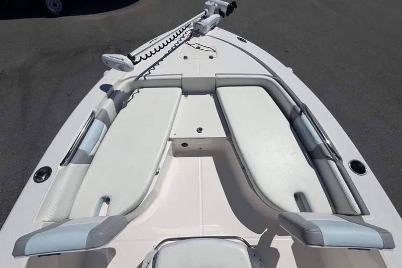 Slide: The Image of The image shows the bow of a 2024 Robalo 206 Cayman boat with cushioned seating areas. - 23