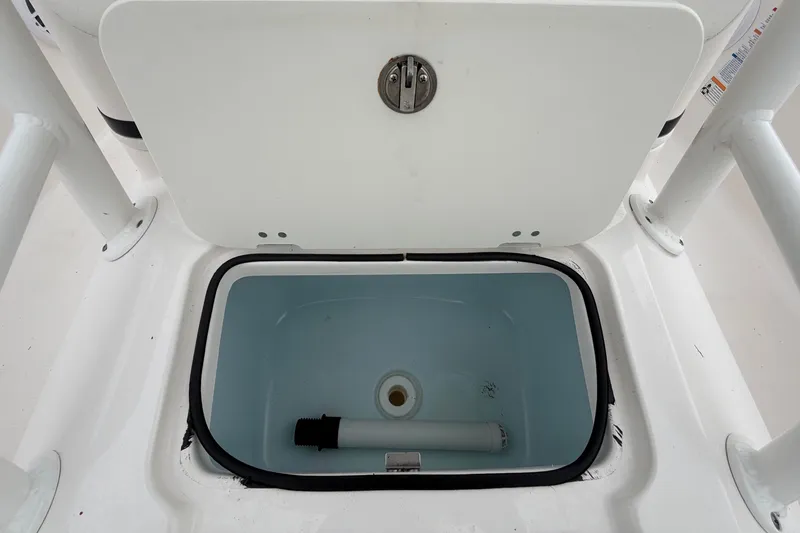 Slide: The Image of An open storage compartment on a Robalo 206 Cayman boat, showing an empty rectangular container. - 42