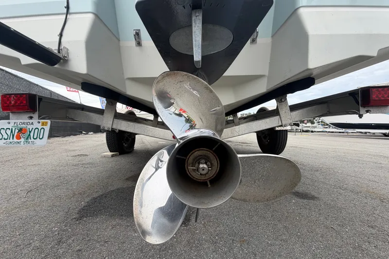 Slide: The Image of 2024 Robalo 206 Cayman boat on trailer, showing propeller and Florida license plate. - 5