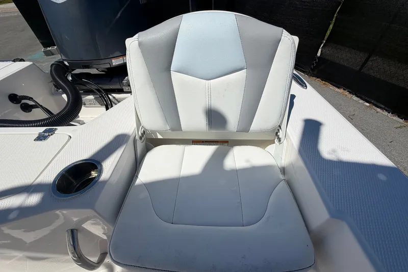 Slide: The Image of 2024 Robalo 206 Cayman boat seat with cup holder and engine in background. - 33