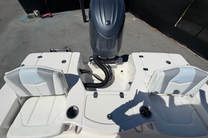 Slide: The Image of 2024 Robalo 206 Cayman boat interior with seating and engine view. - 34