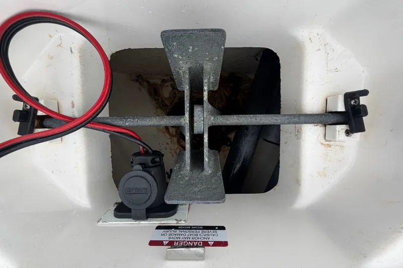 Slide: The Image of An anchor compartment with an anchor and cables inside a boat. - 34