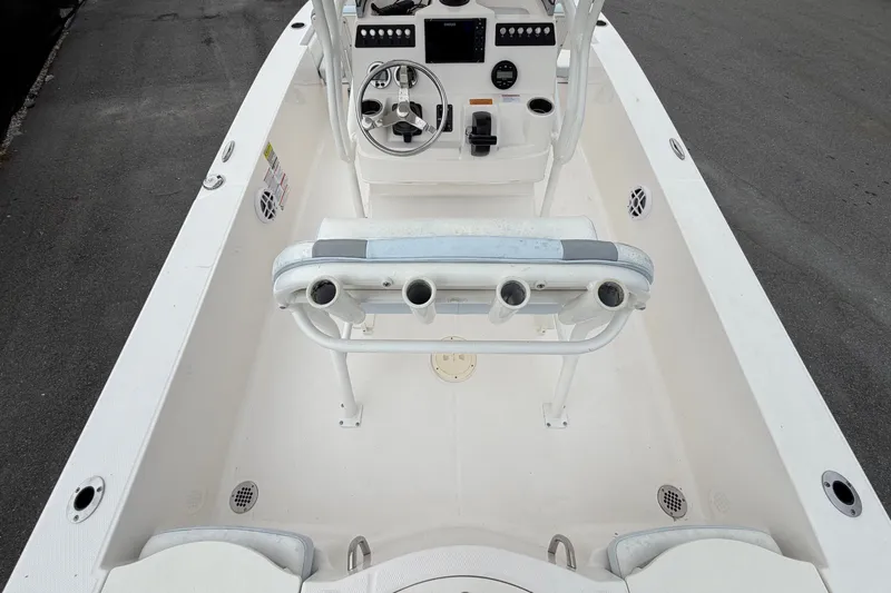 Slide: The Image of The image shows the cockpit of a 2024 Robalo 206 Cayman boat with helm and seating. - 13
