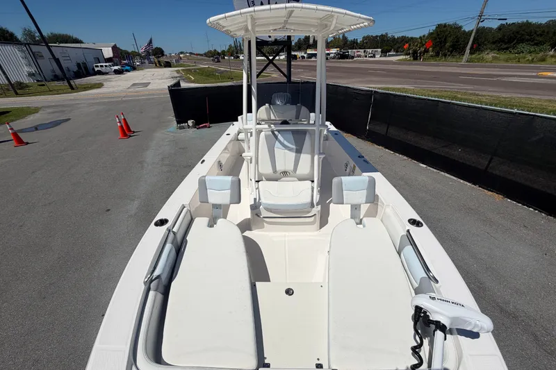 Slide: The Image of 2024 Robalo 206 Cayman boat with spacious deck and seating, parked outdoors. - 26