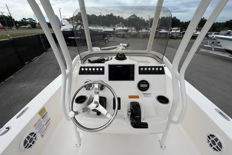 Slide: The Image of 2024 Robalo 206 Cayman boat console with steering wheel and controls. - 16