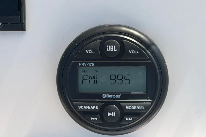 Slide: The Image of JBL PRV-175 radio display on 2024 Robalo 206 Cayman boat, tuned to FM 99.5. - 19