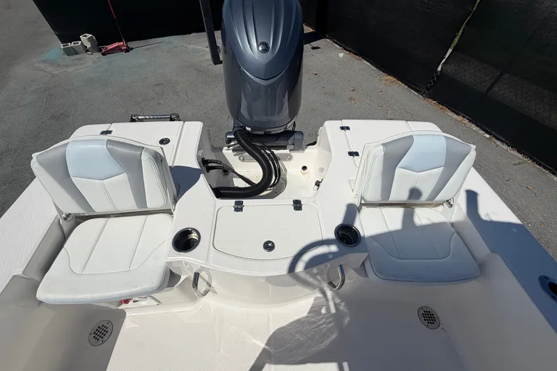 Slide: The Image of 2024 Robalo 206 Cayman boat interior with dual seats and motor. - 31