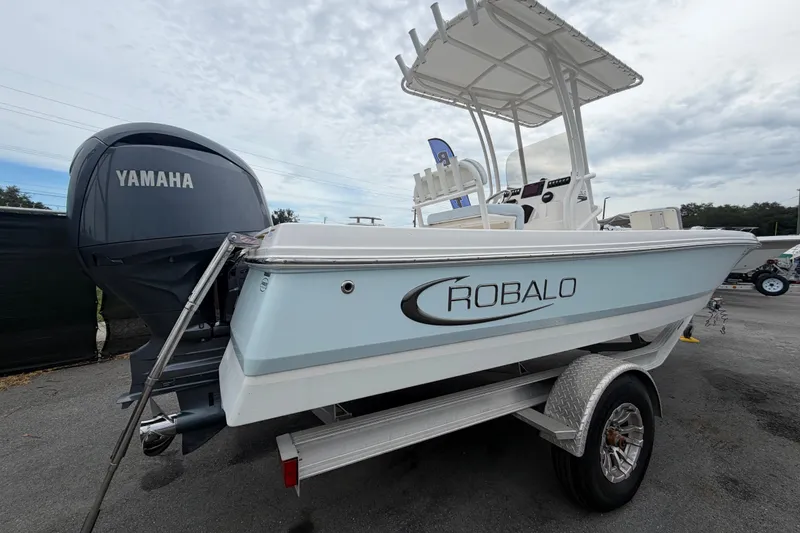 Slide: The Image of 2024 Robalo 206 Cayman boat with Yamaha engine on trailer, outdoor display. - 2