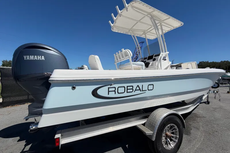 Slide: The Image of 2024 Robalo 206 Cayman boat with Yamaha engine on trailer, side view. - 2