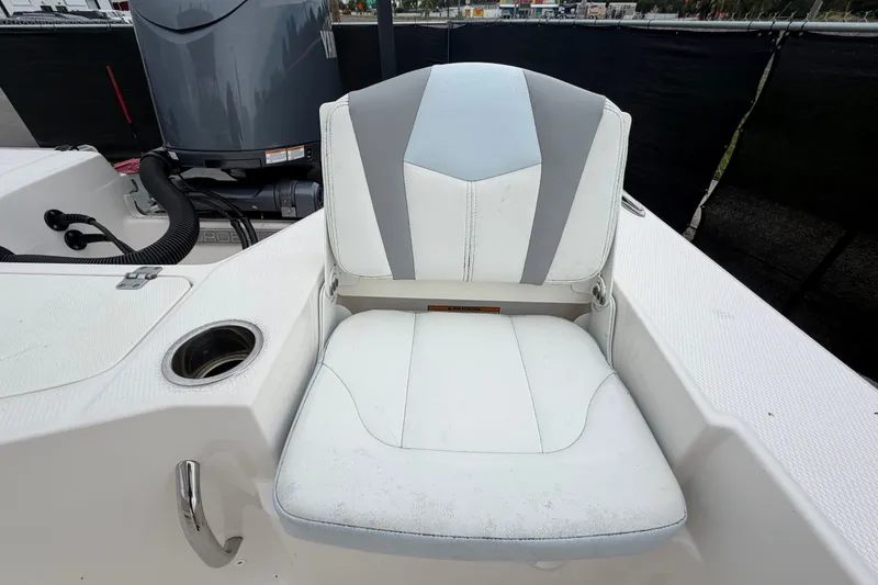 Slide: The Image of 2024 Robalo 206 Cayman boat seat with cup holder and engine in background. - 54