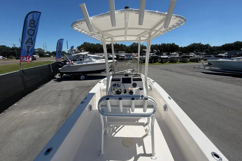 Slide: The Image of 2024 Robalo 206 Cayman boat on display at a sale event, sunny day. - 11