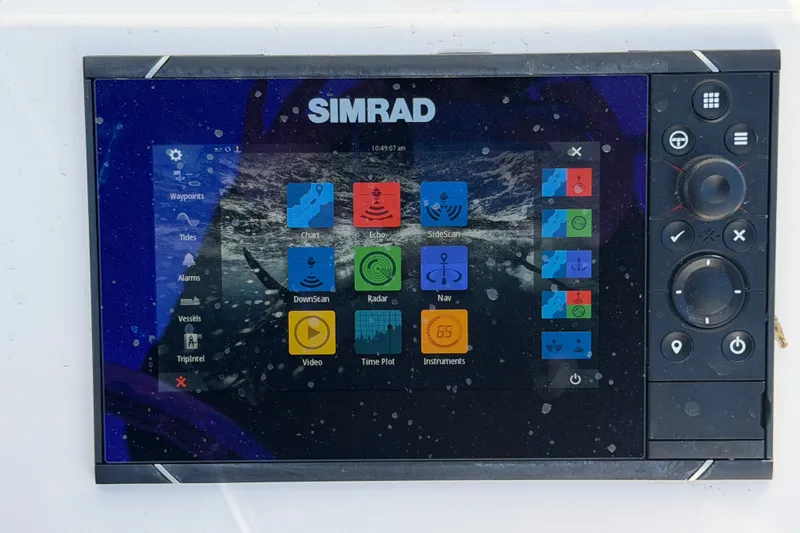 Slide: The Image of Simrad navigation display on 2024 Robalo 206 Cayman boat, showing various marine functions. - 16