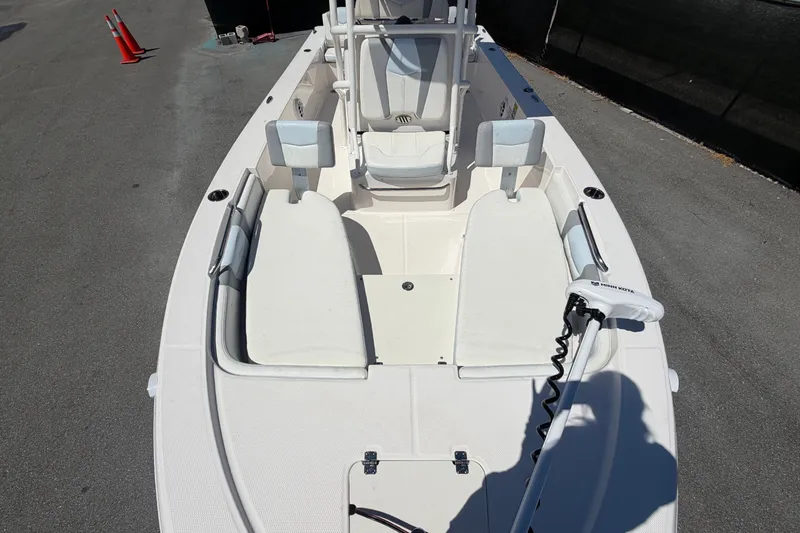 Slide: The Image of The image shows the deck of a 2024 Robalo 206 Cayman boat with white seating and a helm station. - 25