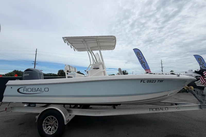 Slide: The Image of 2024 Robalo 206 Cayman boat on trailer, side view with Yamaha engine. - 1