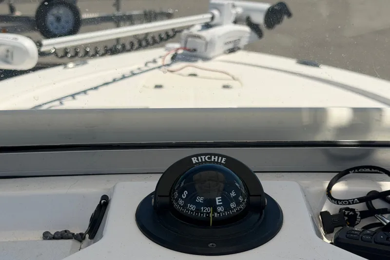Slide: The Image of 2024 Robalo 206 Cayman boat dashboard with compass and navigation equipment. - 21