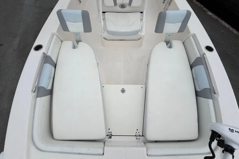 Slide: The Image of The image shows the cockpit of a 2024 Robalo 206 Cayman with white and gray upholstery. - 38