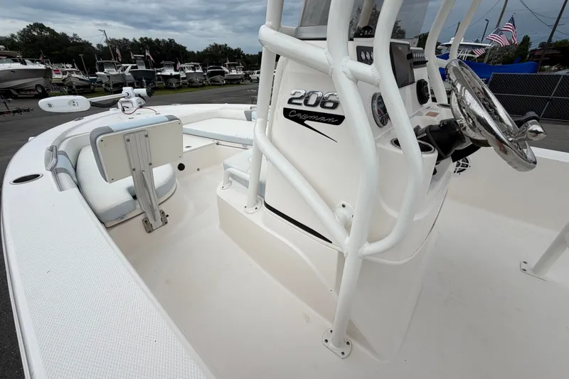 Slide: The Image of 2024 Robalo 206 Cayman boat interior with steering console and seating area. - 23