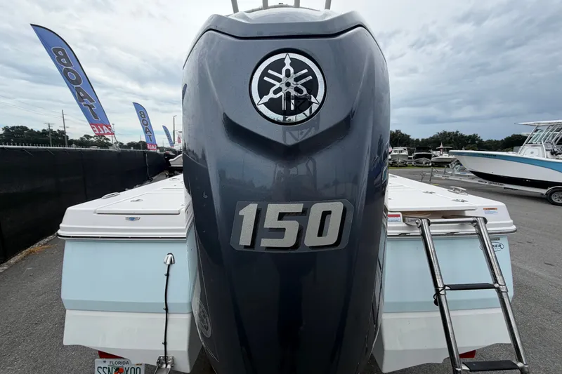 Slide: The Image of 2024 Robalo 206 Cayman boat with Yamaha 150 engine at a boat sale event. - 3