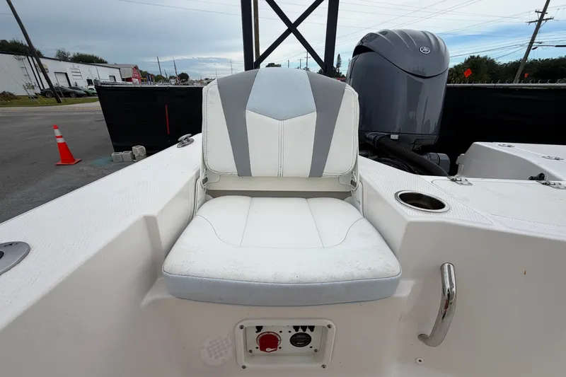 Slide: The Image of 2024 Robalo 206 Cayman boat seat with cup holder and engine in background. - 48