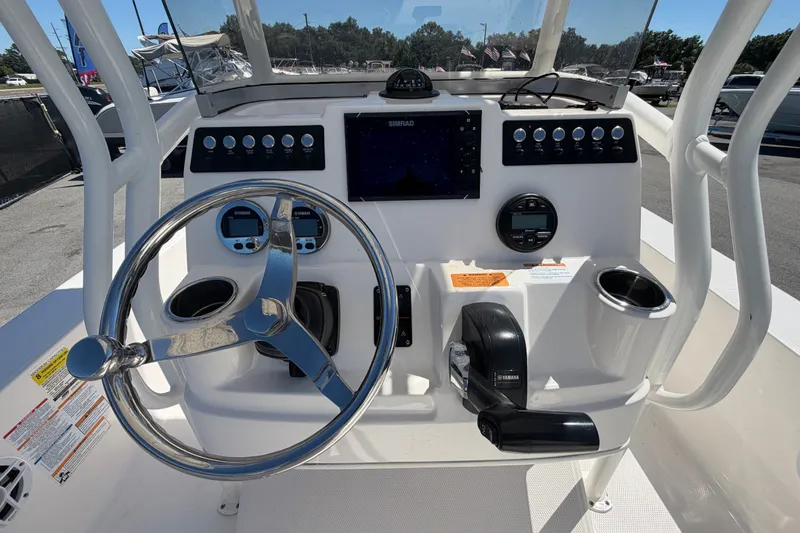 Slide: The Image of 2024 Robalo 206 Cayman boat dashboard with steering wheel and control panel. - 14