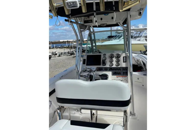 Slide: The Image of 2013 Wellcraft 30 Scarab Sport boat cockpit with steering wheel and control panel. - 8