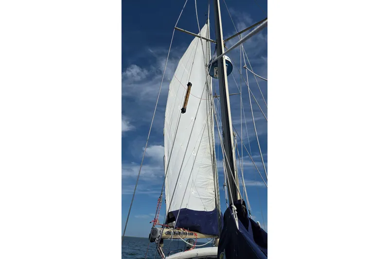 Slide: The Image of Sailing on a 1977 Camper & Nicholsons 42 Ketch under clear blue skies. - 2