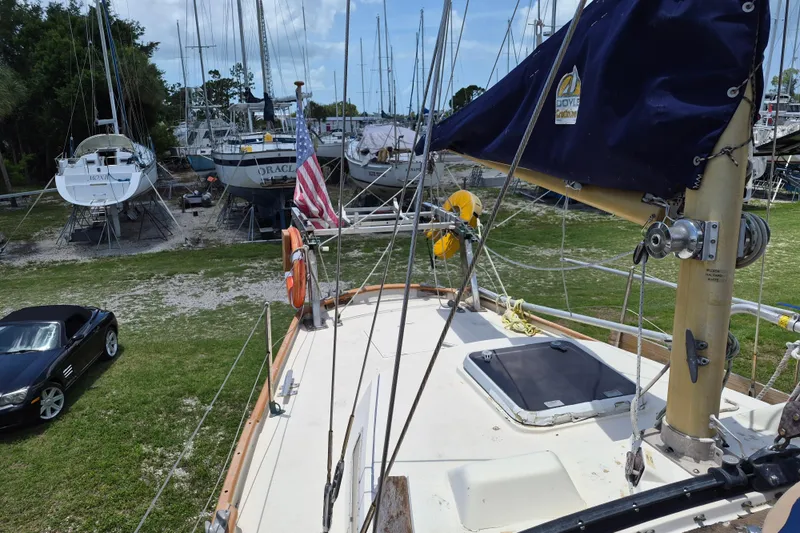 Slide: The Image of 1977 Camper & Nicholsons 42 Ketch in dry dock with cars and other boats. - 4