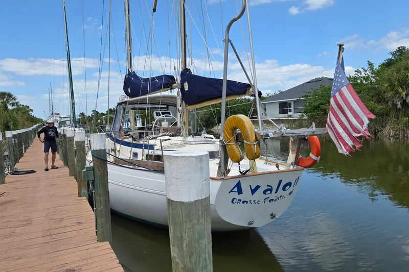 Slide: The Image of 1977 Camper & Nicholsons 42 Ketch docked, displaying American flag and life rings. - 1