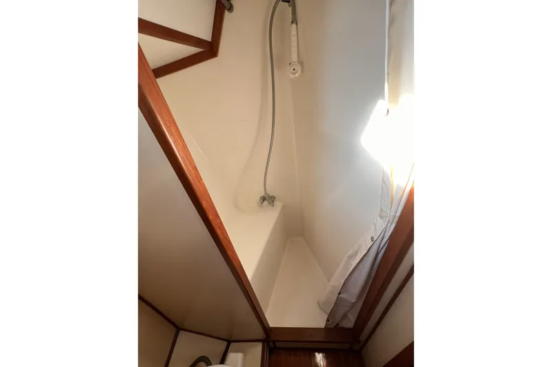 Slide: The Image of Shower area inside 1981 Nordic Boats 40, featuring wooden trim and white walls. - 39
